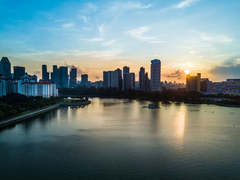 View of city at waterfront during sunset