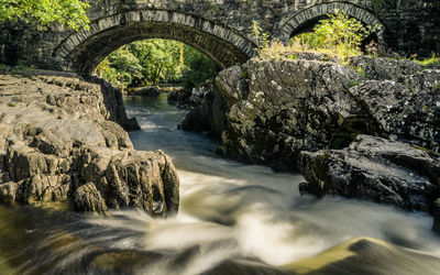 Arch bridge over river stream