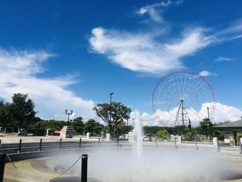 Ferris wheel in city against sky