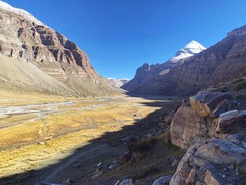Scenic view of mountains against blue sky