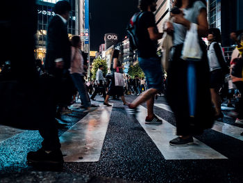 Low section of people walking on street