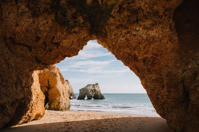 Scenic view of sea seen through cave