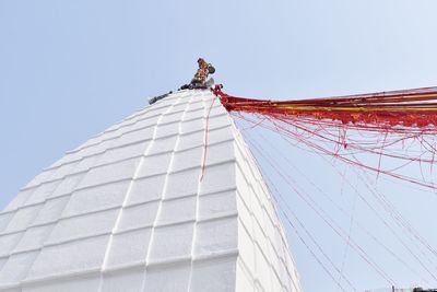 Low angle view of crane against clear sky