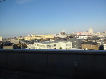 Cityscape against clear blue sky
