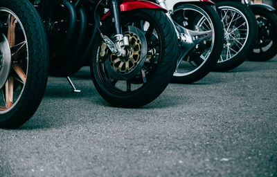 Close-up low section of motorcycle on road