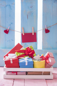 Close-up of multi colored gifts in box