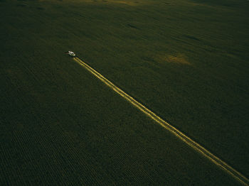 Aerial view of machinery working in agricultural field