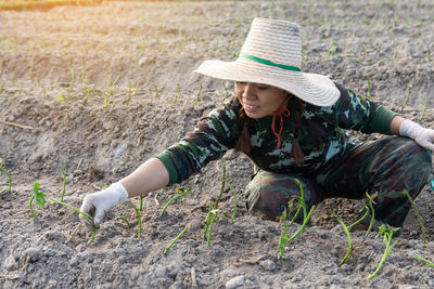 High angle view of senior woman sitting on land