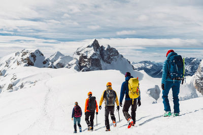 People skiing on snowcapped mountain