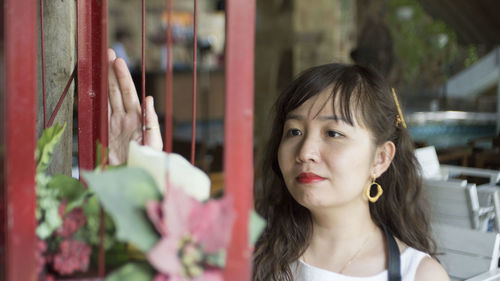 Woman touching metal gate