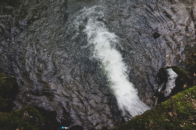 High angle view of waterfall amidst rocks