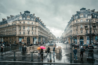 People on wet street in rainy season