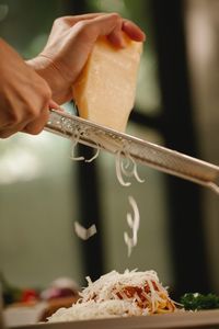 Cropped hand of person preparing food