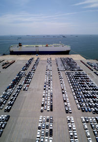 High angle view of commercial dock by sea against sky