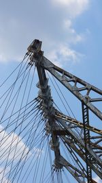 Low angle view of electricity pylon against sky