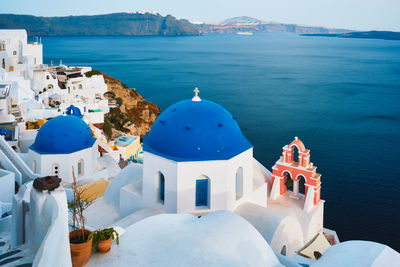 Famous view viewpoint of santorini oia village with blue dome of greek orthodox christian church