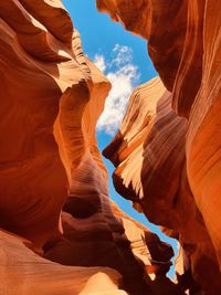 Low angle view of red rock canyon formations with blue sky above