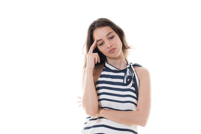 Young woman standing against white background