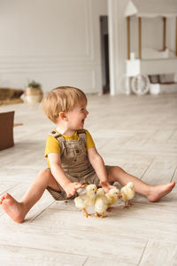 Boy playing with ducks for easter