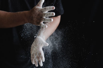 Midsection of person splashing water