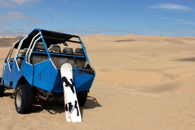 Scenic view of desert against blue sky