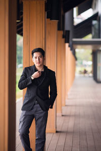 Portrait of confident young man standing in corridor