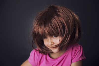 Portrait of girl against black background