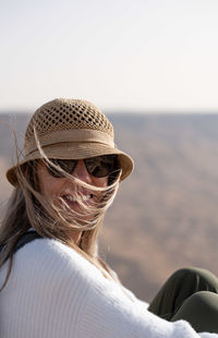 Side view of woman wearing hat