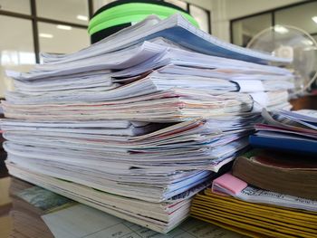 Stack of papers at desk in office