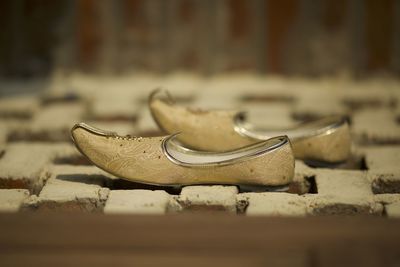 Close-up of old shoes on footpath