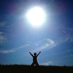Silhouette man standing on field against sky