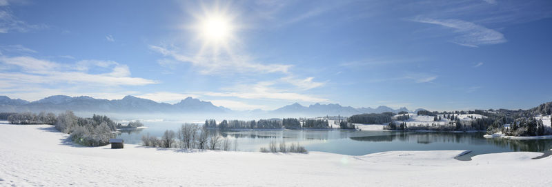 Scenic view of snowcapped lake against sky during winter