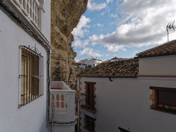 Low angle view of buildings in town against sky