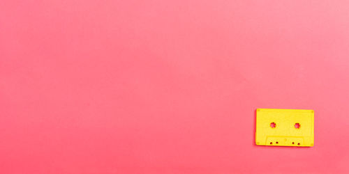 Close-up of stuffed toy against pink wall