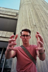 Portrait of young man wearing sunglasses standing outdoors