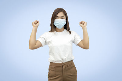 Portrait of woman standing against white background