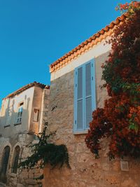 Low angle view of building against clear blue sky