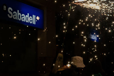 Low angle view of illuminated sign at night