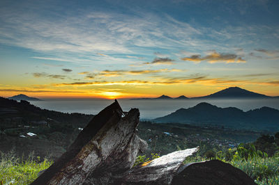 Scenic view of silhouette mountains against sky during sunset