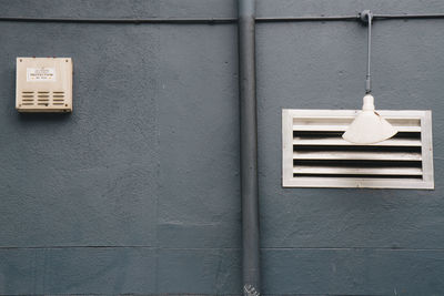 Close-up of electric lamp hanging on wall