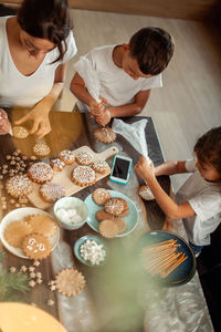 High angle view of people holding food on table