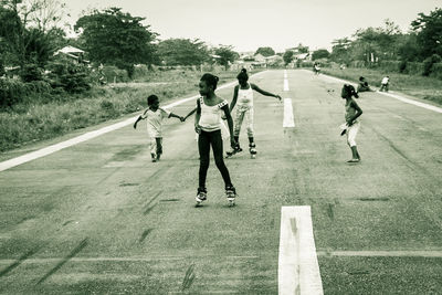 Group of people playing on road