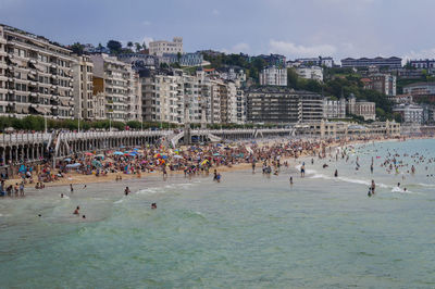 Group of people on beach in city