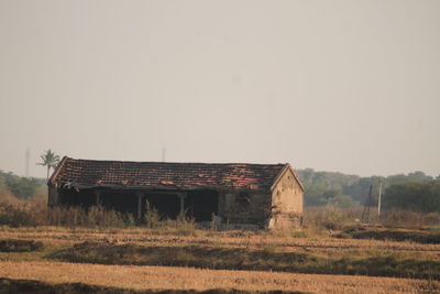 Barn on field against sky