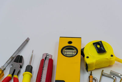 Close-up of yellow colored pencils against white background