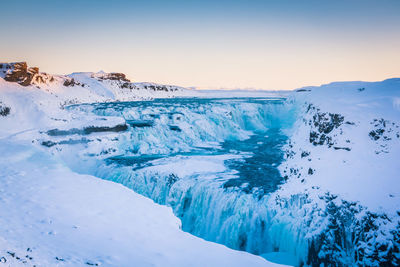 Scenic view of snowcapped landscape against sky during winter