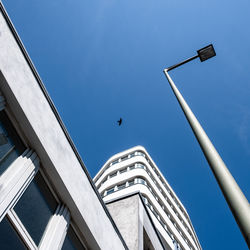 Low angle view of bird flying against sky