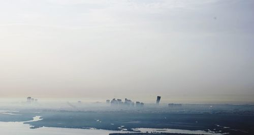 Scenic view of sea against sky in city