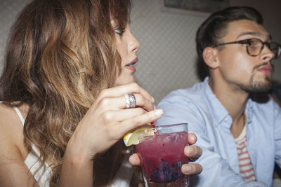 Close-up of a young woman drinking glass