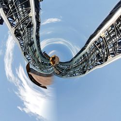 Low angle view of modern building against blue sky